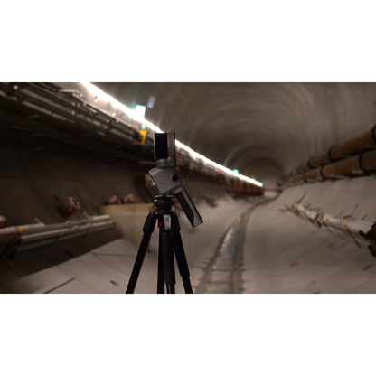 FJD Trion T1 mounted on a tripod for terrestrial laser scanning inside a concrete tunnel with overhead lighting.