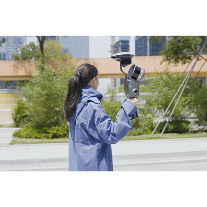 surveyor using the XGRIDS L2 Pro survey grade RTK kit with GNSS receiver and antenna for georeferenced LiDAR mapping in an outdoor environment