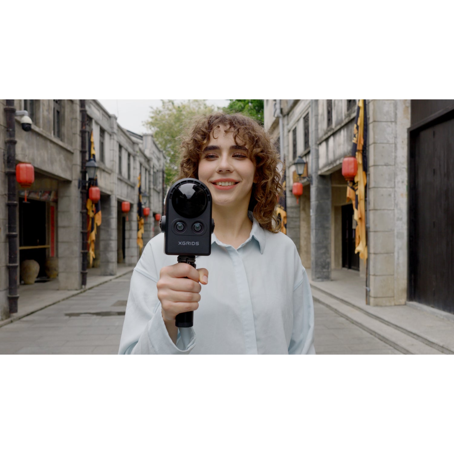 professional using the XGRIDS PortalCam handheld SLAM LiDAR scanner for outdoor 3D mapping