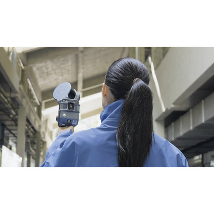 surveyor using XGRIDS Lixel L2 Pro real-time RTK SLAM LiDAR scanner for scanning the inside of a business complex in low light