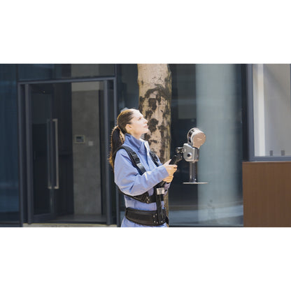 surveyor using XGRIDS Lixel L2 Pro real-time RTK SLAM LiDAR scanner for scanning the outdoor areas of a business complex in sunlight