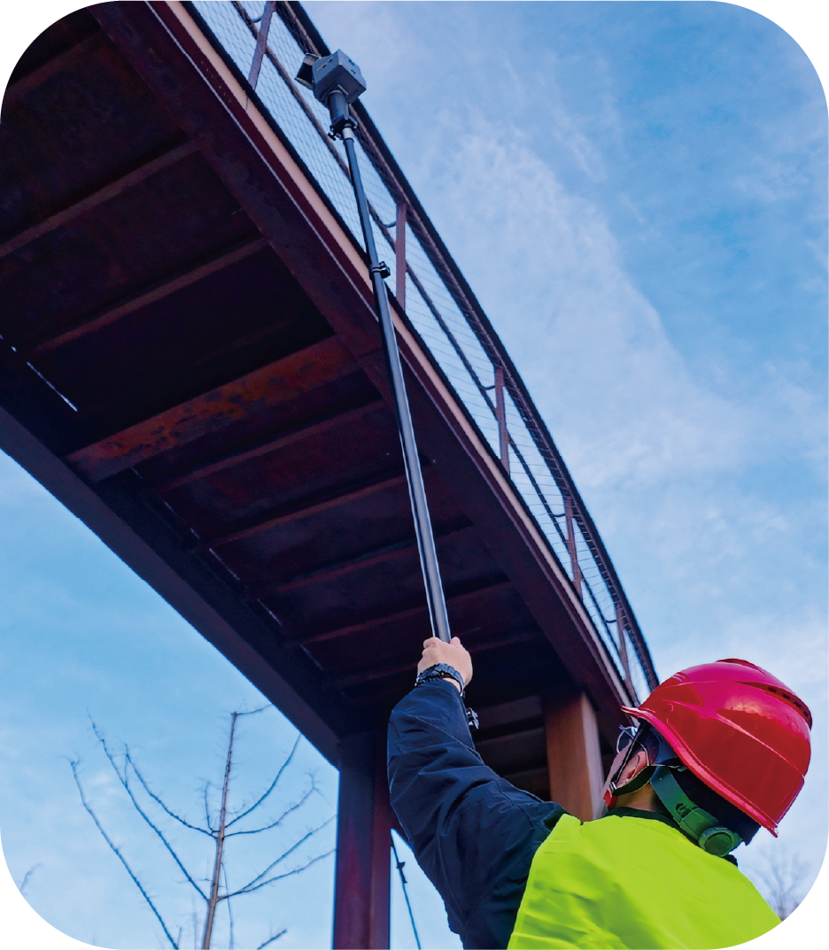 surveyor using the FJ Dynamics Trion Quick-Detach Extension Pole – carbon fiber with the Trion S2 and P2 Slam scanners for outdoor vertical accuracy