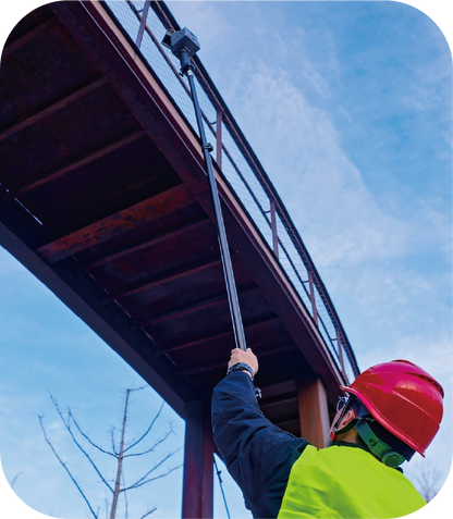 surveyor using the FJ Dynamics Trion Quick-Detach Extension Pole – carbon fiber with the Trion S2 and P2 Slam scanners for outdoor vertical accuracy